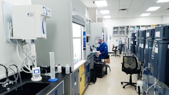 A person sitting on a chair in a biotech lab researching biotech lead generation