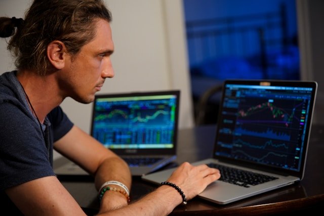 A person sitting at a desk looking at a computer discussing the need for lead generation for financial advisors