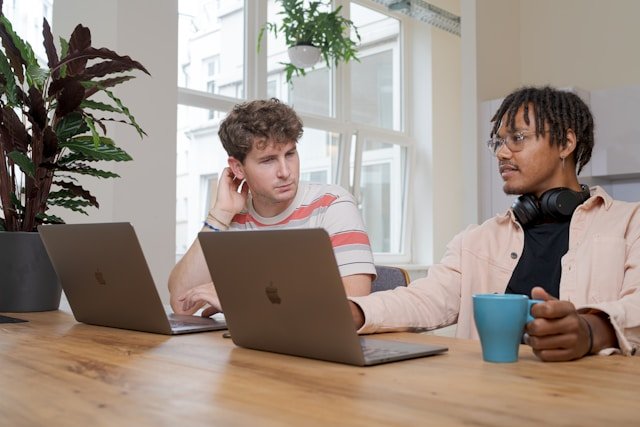 Two people at a table discussing saas lead gen