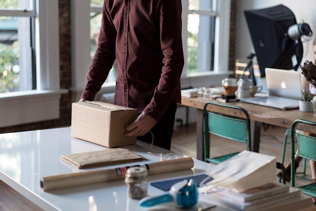 A person opening a box showing the need for lead generation for small business
