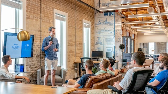 A person presenting in front of a team about saas lead generation